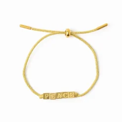 INK + ALLOY Goldie Gold Lurex Cord With Brass Letters Adjustable Peace