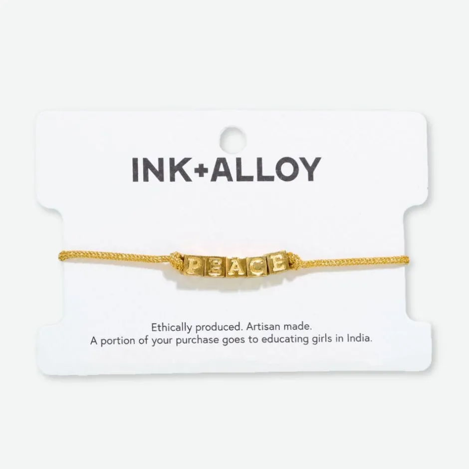 INK + ALLOY Goldie Gold Lurex Cord With Brass Letters Adjustable Peace