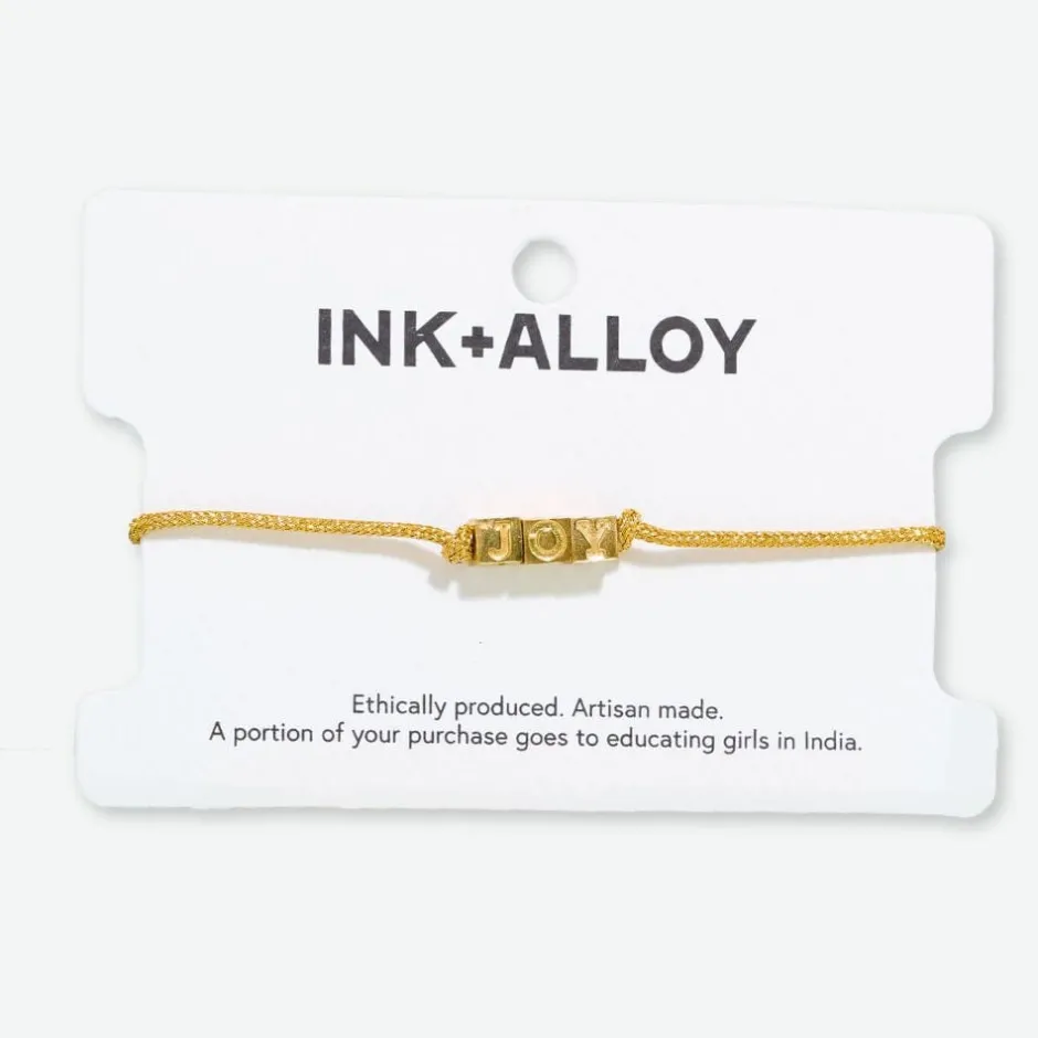 INK + ALLOY Goldie Gold Lurex Cord With Brass Letters Adjustable Joy